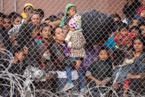 Migrants Waiting Outside Fence At Border